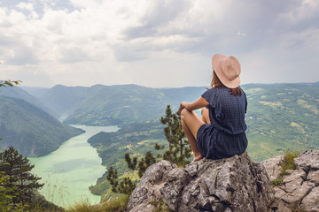 Woman relaxing on mountain view.