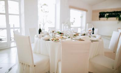  Dinner table decoration in white colors in the restaurant. Catering service