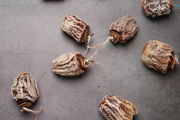 dried persimmons on a gray background