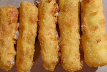 Cheese sticks on a wooden tray. Close-up. Junk food.