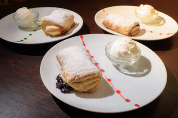 Three servings of strudel with ice cream. Tasty and not bad food.
