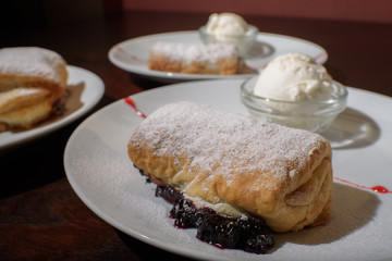 Three servings of strudel with ice cream. Tasty and not bad food.