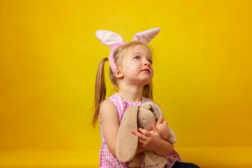 Easter concept. Toddler blonde happy  girl with bunny ears