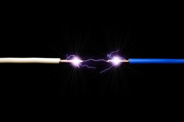 The concept of a short circuit. A spark or electric discharge of 10000 Volts occurs between the two wires. Dark background.
