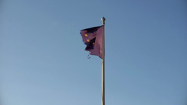 Torn damaged flag of European Union in stormy weather, Collapse of EU abstract concept