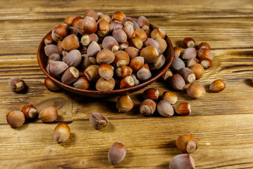 Hazelnuts in ceramic plate on a wooden table