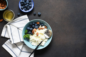 Beautiful breakfast - cottage cheese, berries and honey on the kitchen table. Good morning.