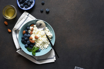 Beautiful breakfast - cottage cheese, berries and honey on the kitchen table. Good morning.