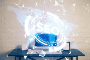 Multi exposure of table with computer and seo drawing hologram. Search optimization concept.