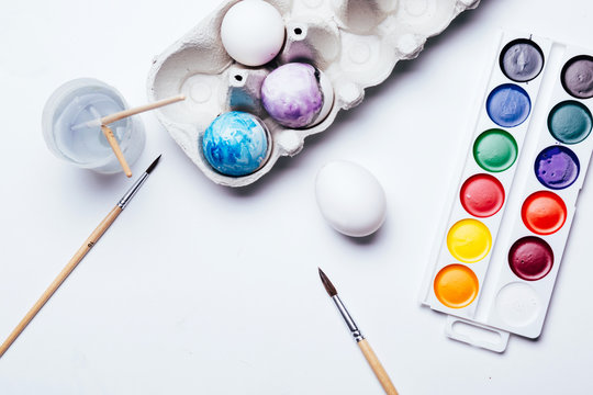 Drawing eggs for Easter on white background, concept of happy holiday and family unification