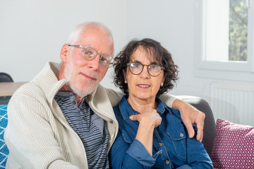 Senior couple relaxing on sofa at home