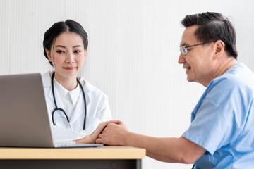 Young Asian doctor woman reassuring and discussing senior patient man in the hospital room.