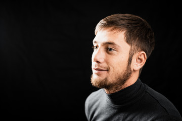 Portrait of a bearded handsome man on a black background