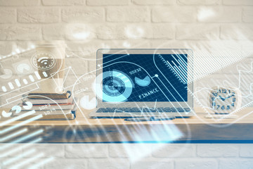 Computer on desktop in office with technology theme hologram. Multi exposure. Tech concept.