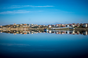 Naklejka na ściany i meble panorama of the city reflected at the lake