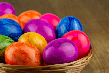 Fototapeta na wymiar colorful easter eggs in an easter basket closeup