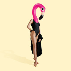 Ballet dancer headed by swim flamingo on yellow background. Copyspace to insert your text. Modern...