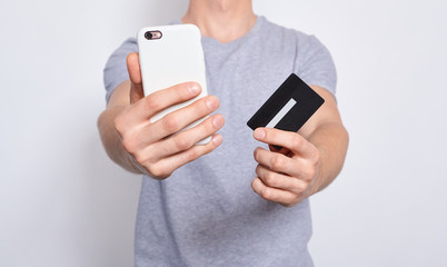 Photo of handsome man with credit card and smartphone.