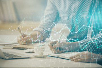 Multi exposure of forex chart with man working on computer on background. Concept of market...