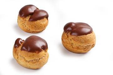 cream and chocolate puffs isolated on white background