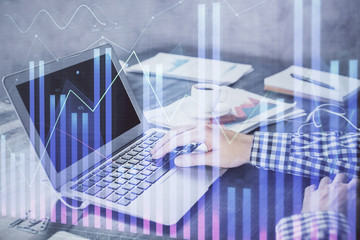 Double exposure of forex chart with man working on computer on background. Concept of market analysis.