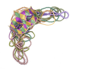 holiday or mardi gras beads and mask making frame isolated on white background © vetre
