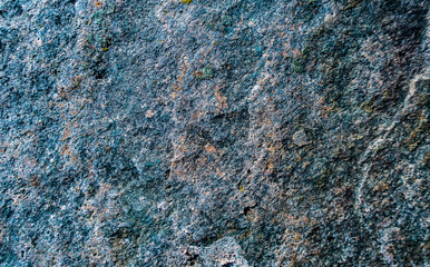 Surface of stone rock as grungy scratchy grainy texture yellow background toned in cold colors