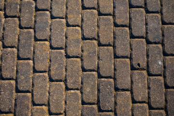 Brick stone paved road surface as texture background