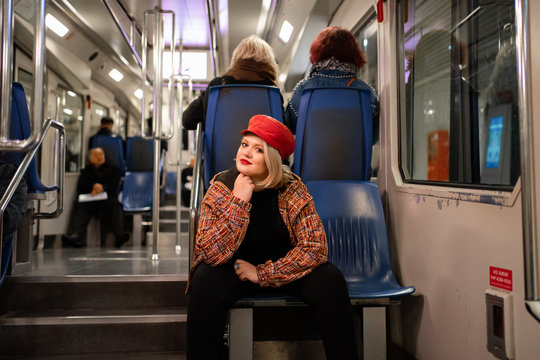 Full Blonde Sitting In A Subway Car Or Funicular