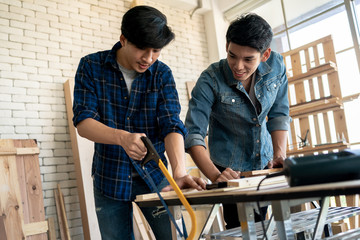 Two young carpenters working at location.