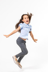 little girl jumps on a white background