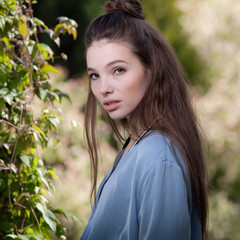 Fototapeta premium Portrait of beautiful young girl in summer garden.