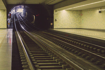 Fototapeta premium Empty subway station filtered. Underground platform. Railway in perspective. Urban transport concept. Travel background. Transportation concept. Subway line. 