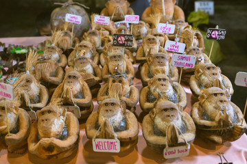 Coconut figurine or doll in the form of a monkey who invites to Koh Samui in Thailand. Travel souvenir gift