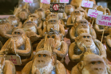 Coconut figurine or doll in the form of a monkey who invites to Koh Samui in Thailand. Travel souvenir gift