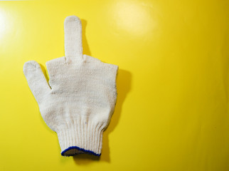glove symbol with outstretched middle finger on a yellow background