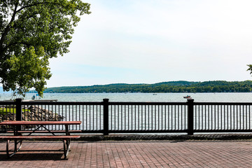 View of Canandaigua lake from the pedestrian bridge.  Picnic table on the bridge and shoreline in the distance