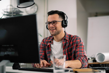Businessman on video call. Handsome man in office with headphones. 