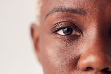 Close Up On Eyes Of Young Woman With Dyed Hair In Studio - Powered by Adobe