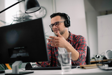 Businessman on video call. Handsome man in office with headphones. 