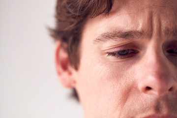 Fototapeta premium Close Up On Face Of Unhappy Man Shot In Studio
