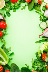 Fototapeta na wymiar Healthy food background with various green herbs and vegetables. Ingredients for cooking salad. Vegetarian and vegan food concept. Top view, copy space