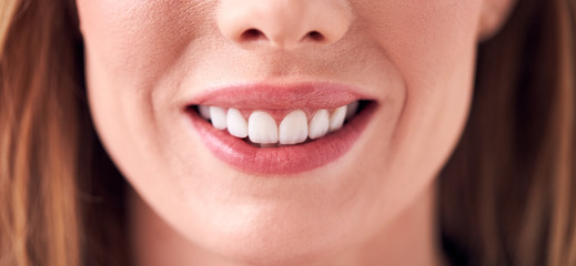Close Up On Mouth Of Smiling Young Woman In Studio