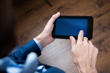 businessman holds tablet in hand