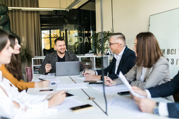 Group of happy young business people in a meeting at office. Business conference