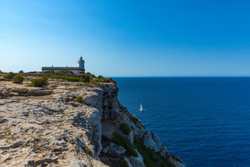 Fototapeta na wymiar Travels-The Cap Blanc Lighthouse is located on the Cape of the same name at the eastern end of the Bay of Palma. Balearic Islands, Mallorca, Spain,
