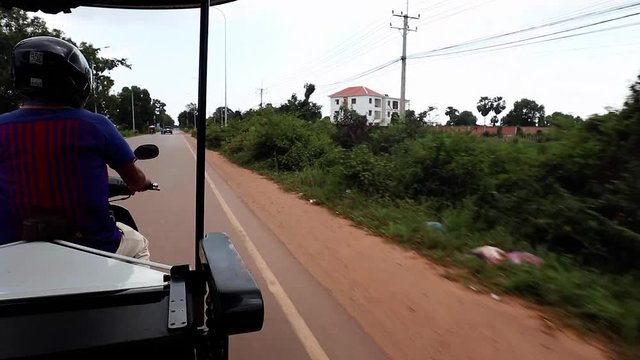 Driving fast in the back of a tuk tuk in Siem Reap, Cambodia.