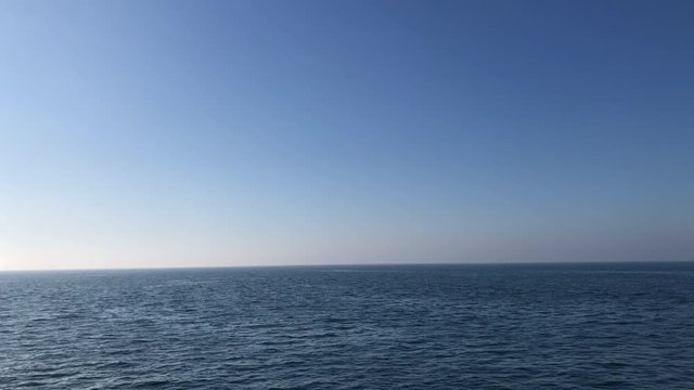 The passenger ferry travels in the immense sea in timelapse,there is no land