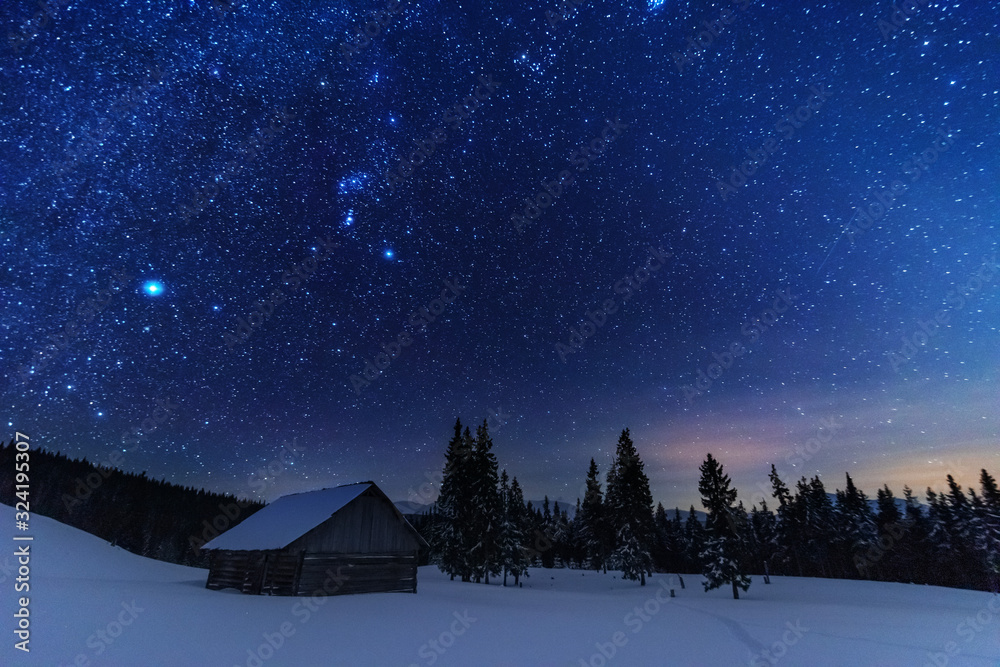Wall mural a bright starry night in the mountains with the milky way in the sky, venus and millions of stars hi