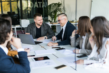 Group of business partners discussing ideas and planning work in office. Team work